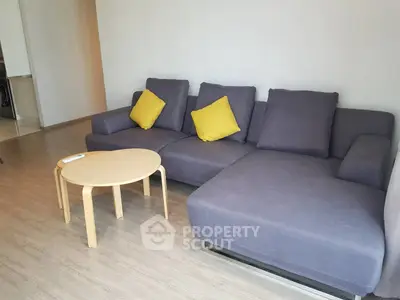 Modern living room with stylish gray sofa and wooden coffee table