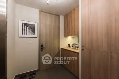 Modern entryway with wooden cabinets and sleek design