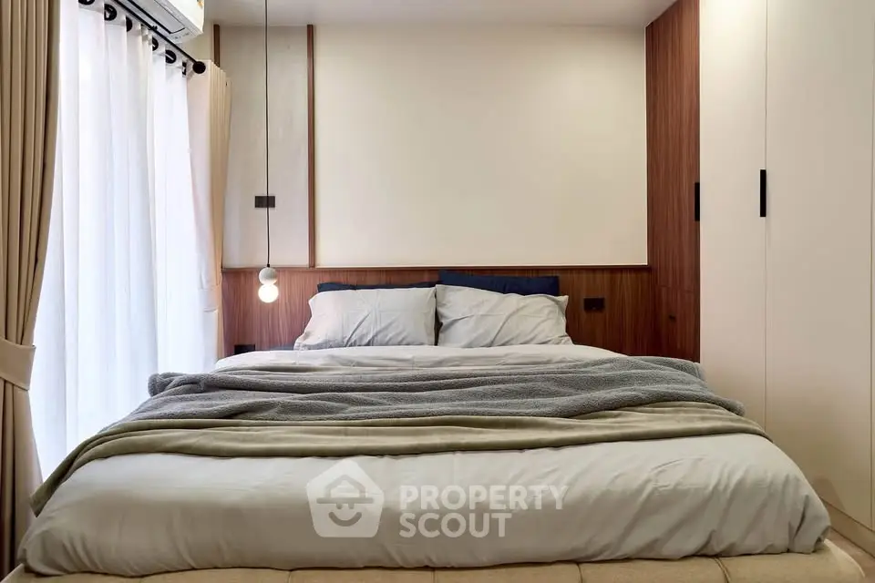 Cozy modern bedroom with elegant lighting and soft bedding