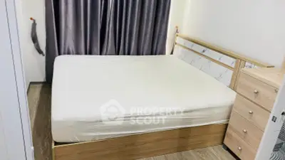 Modern bedroom with stylish bed frame and elegant curtains in a cozy apartment.