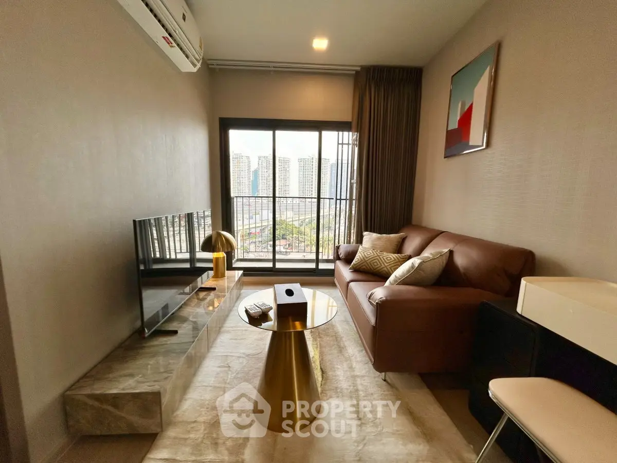 Modern living room with city view, stylish furniture, and elegant decor in a high-rise apartment.