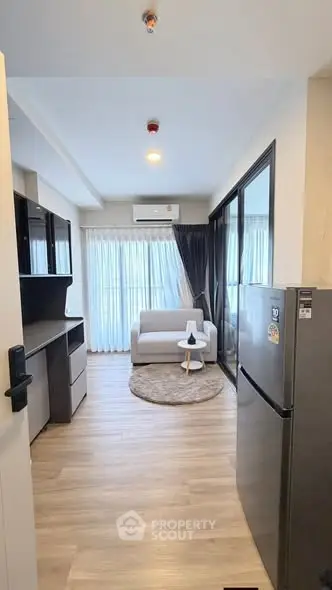 Modern living room with sleek furniture and large windows in a stylish apartment.