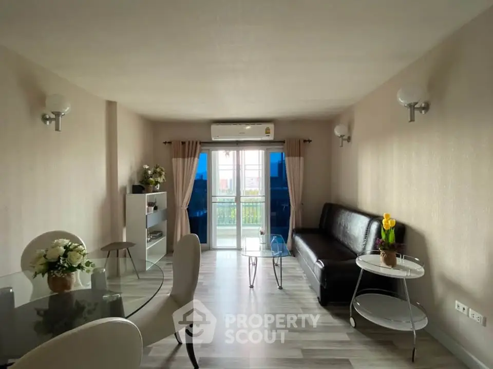 Spacious living room with modern decor and large windows for natural light.