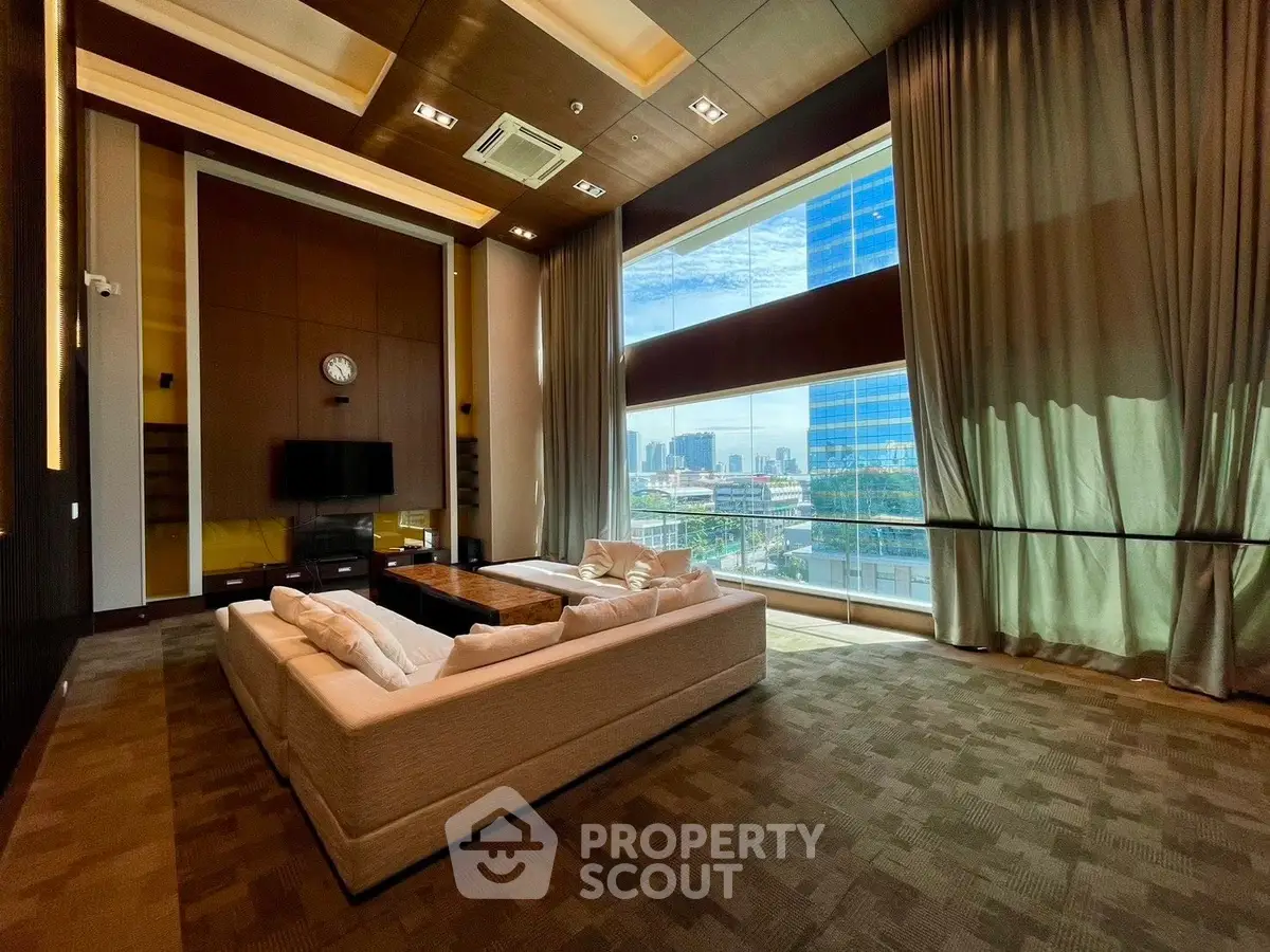 Luxurious living room with floor-to-ceiling windows and stunning city view.