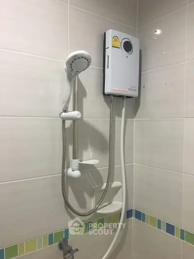 Modern bathroom with electric shower and sleek tile design