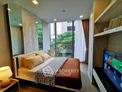 Modern bedroom with large window and stylish decor in urban apartment