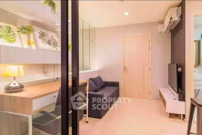 Modern living room with stylish decor and workspace in a cozy apartment.