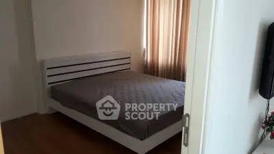Cozy bedroom with modern bed frame and natural light from window