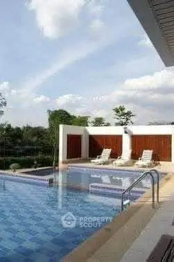 Luxurious outdoor pool area with sun loungers and scenic views, perfect for relaxation and leisure.