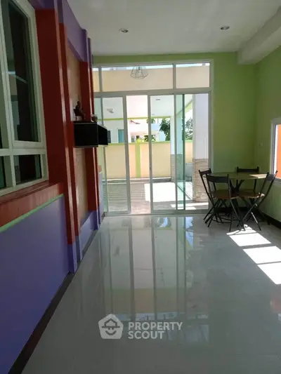 Bright interior with colorful walls and glass doors leading to a patio