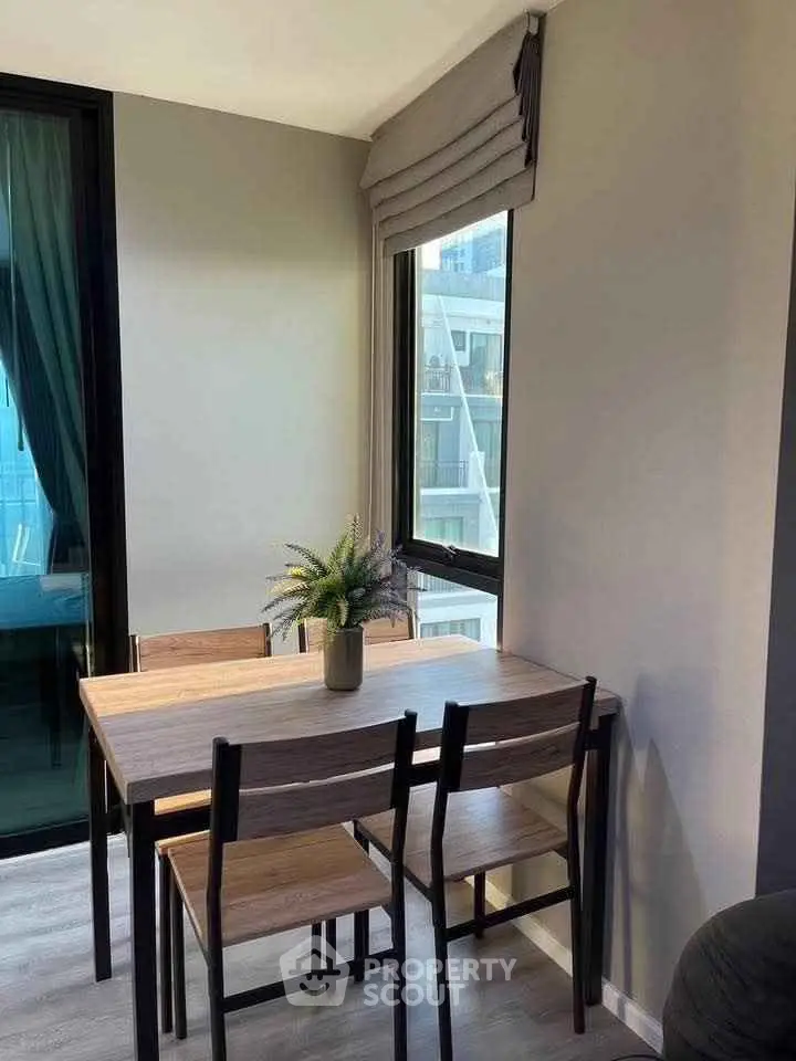 Cozy dining area with natural light and modern decor in a stylish apartment.