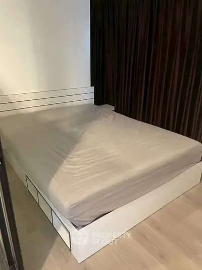 Modern bedroom with sleek bed frame and minimalist design, perfect for urban living.