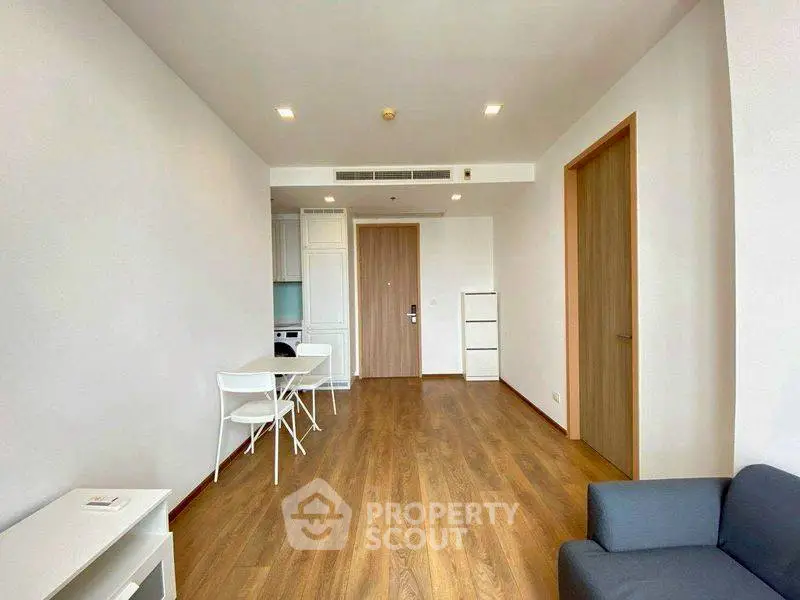 Modern minimalist living room with wooden flooring and sleek furniture