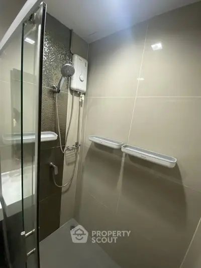 Modern bathroom with sleek shower design and neutral tiles