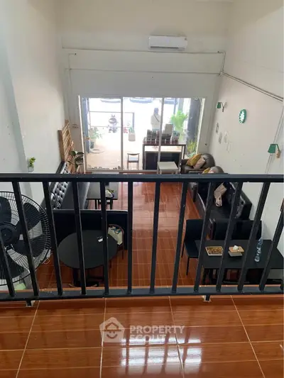 Spacious living room with modern furniture and balcony view, perfect for relaxation and entertaining.