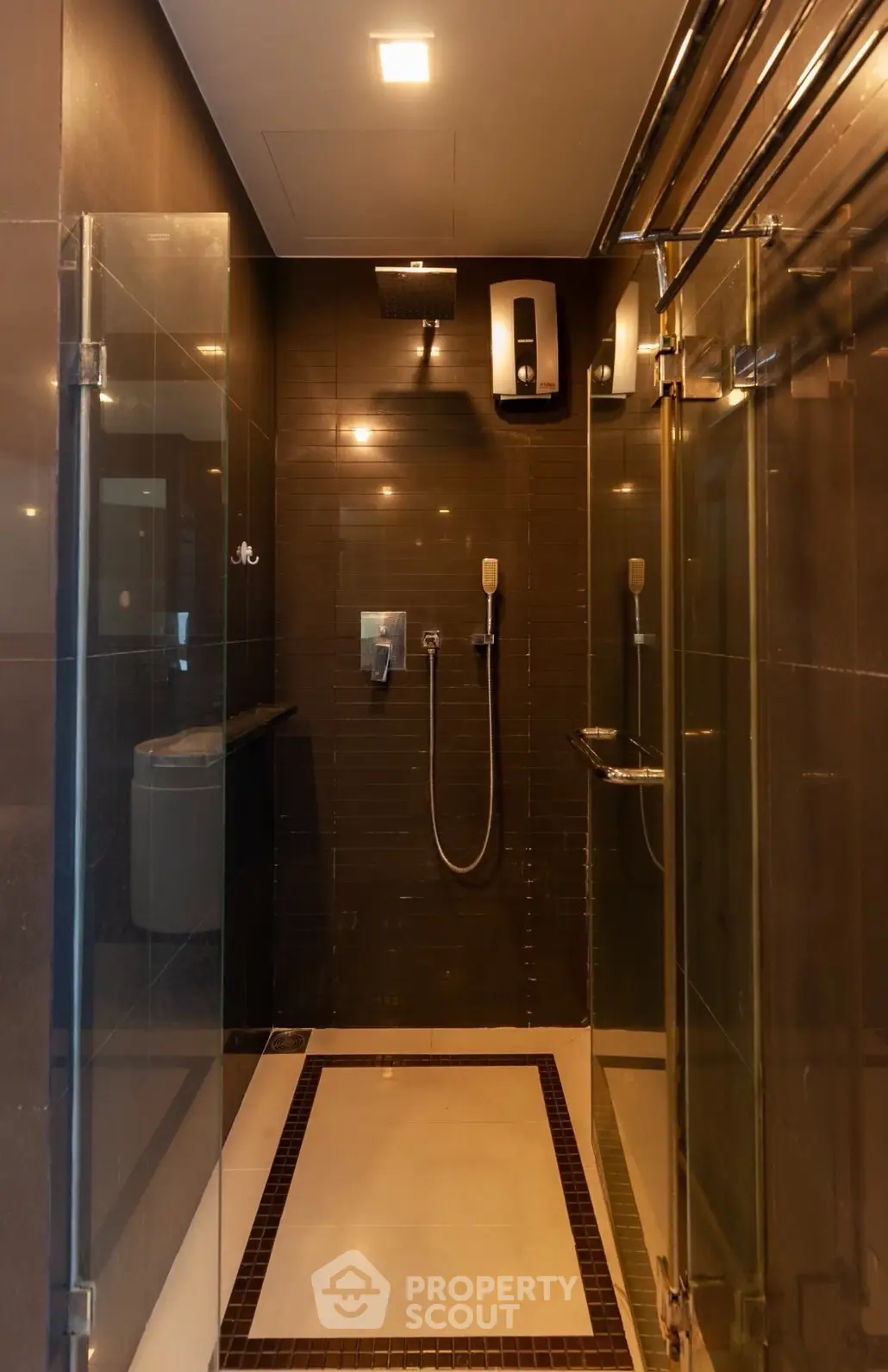 Luxurious modern bathroom with sleek glass shower enclosure and elegant fixtures.