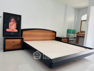 Spacious bedroom with modern bed frame and elegant decor