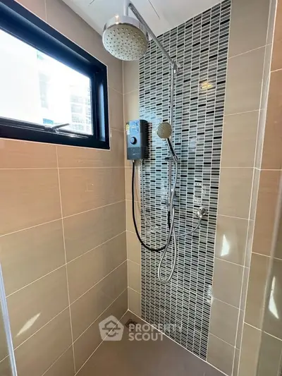 Modern bathroom shower with stylish tile design and large window