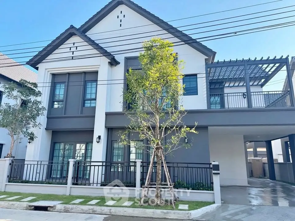 Modern two-story house with stylish facade and spacious driveway in a serene neighborhood.