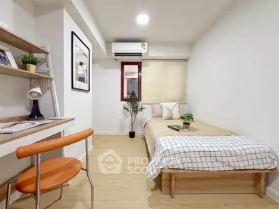 Modern minimalist bedroom with study area, featuring sleek furniture and cozy decor.