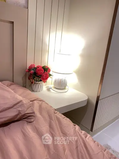 Cozy bedroom corner with elegant lamp and floral decor