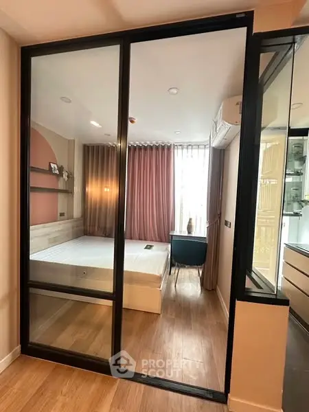 Modern bedroom with glass sliding door and stylish decor
