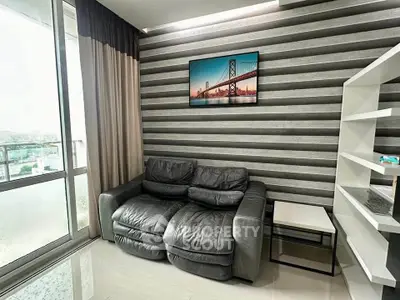 Modern living room with stylish leather sofa and balcony view