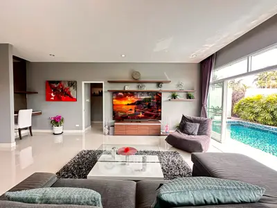 Luxurious living room with pool view and modern decor