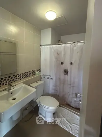 Modern bathroom with stylish fixtures and polar bear shower curtain