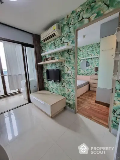 Stylish modern apartment interior with tropical wallpaper and cozy bedroom view.