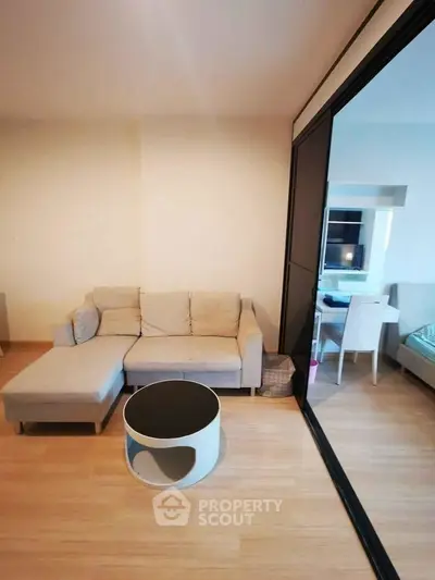 Modern living room with beige sofa and stylish round coffee table