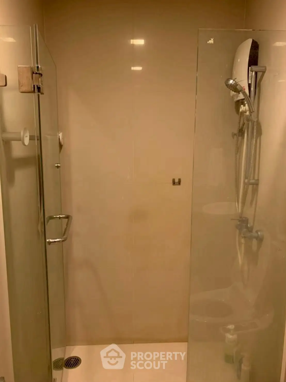 Modern bathroom with glass shower enclosure and sleek fixtures.