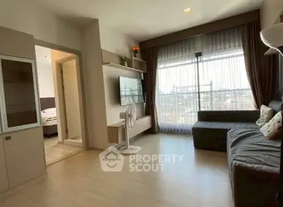 Modern living room with large window and stylish decor in a contemporary apartment.