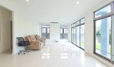 Spacious modern living room with large windows and garden view