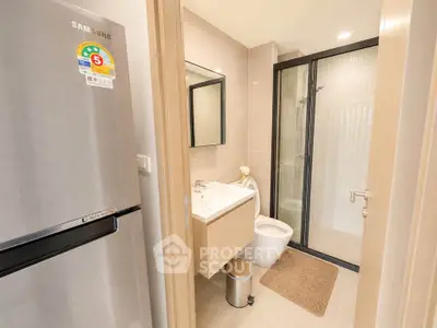 Modern bathroom with sleek design and energy-efficient refrigerator in a contemporary apartment.