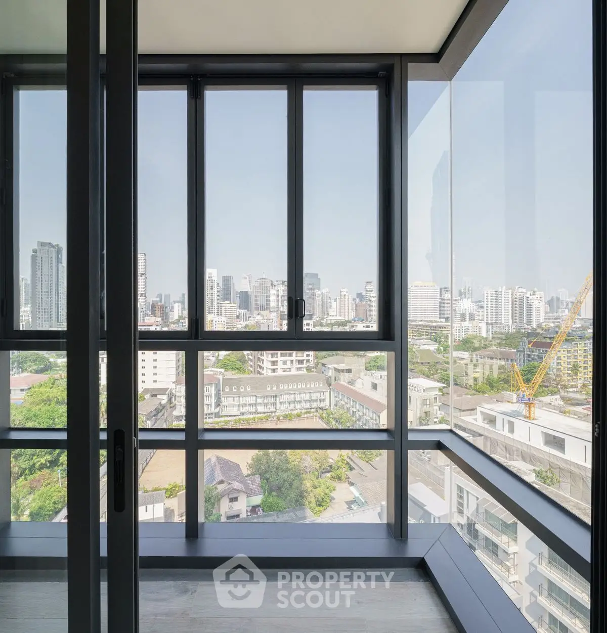 Stunning corner unit with panoramic city view through floor-to-ceiling windows.