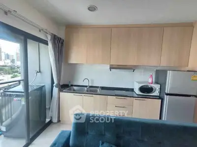 Modern kitchen with sleek cabinets and city view from balcony