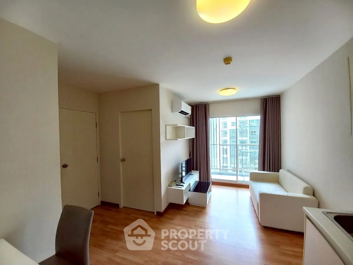 Modern living room with wooden flooring and balcony view