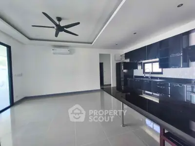 Spacious modern kitchen with sleek black cabinetry and open layout