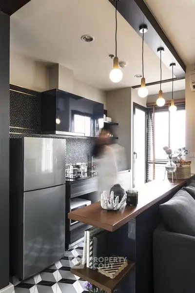 Modern kitchen with sleek design, open layout, and stylish lighting in a contemporary apartment.