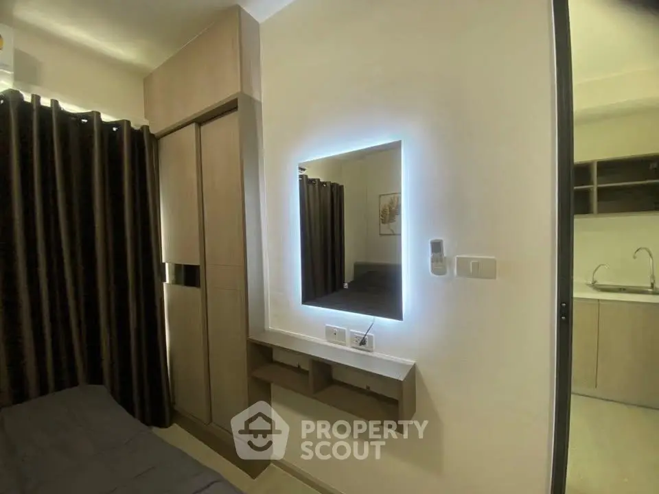 Modern bedroom with illuminated mirror and sleek wardrobe design