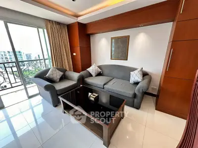 Stylish living room with modern furniture and balcony view in urban apartment.