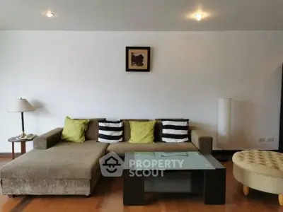 Modern living room with stylish sofa and glass coffee table in a cozy apartment.