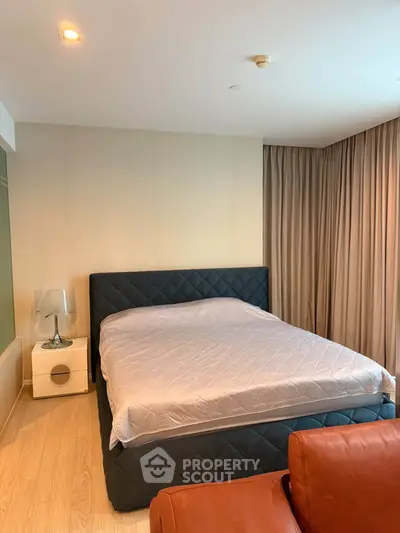 Modern bedroom with stylish bed and cozy lighting in a contemporary apartment.