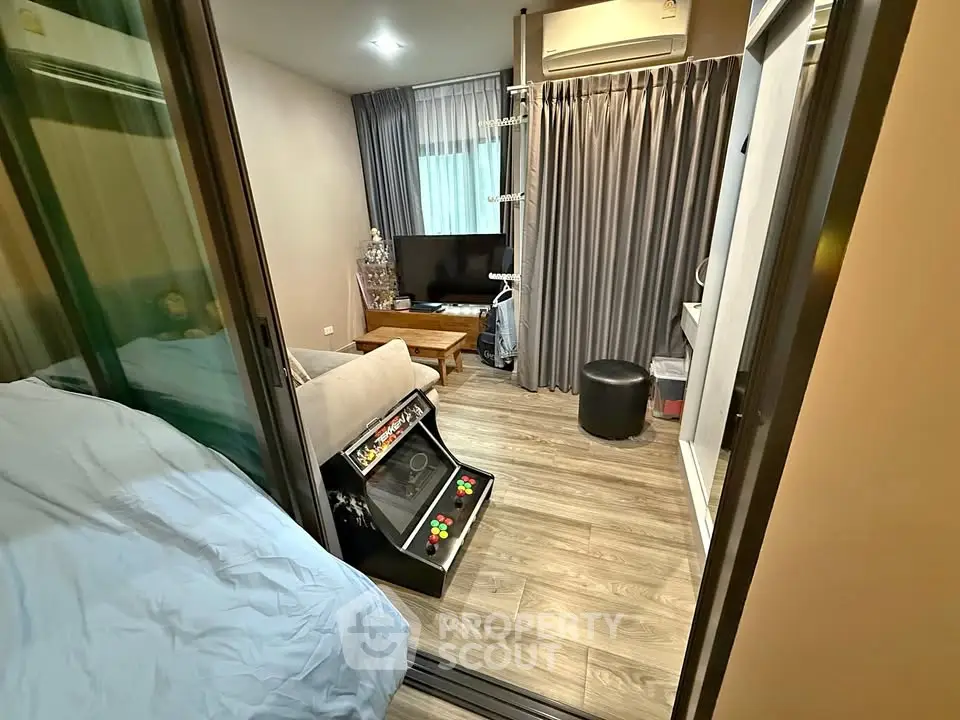 Cozy living room with modern decor and entertainment setup in a stylish apartment.