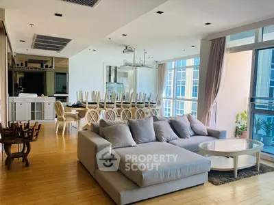 Spacious modern living room with large windows and open kitchen layout