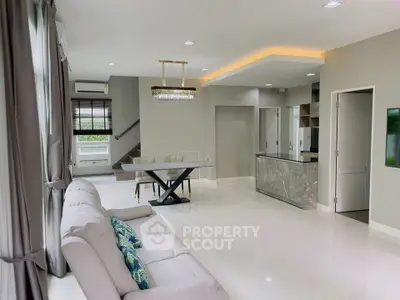 Modern open-plan living room with elegant dining area and stylish kitchen.