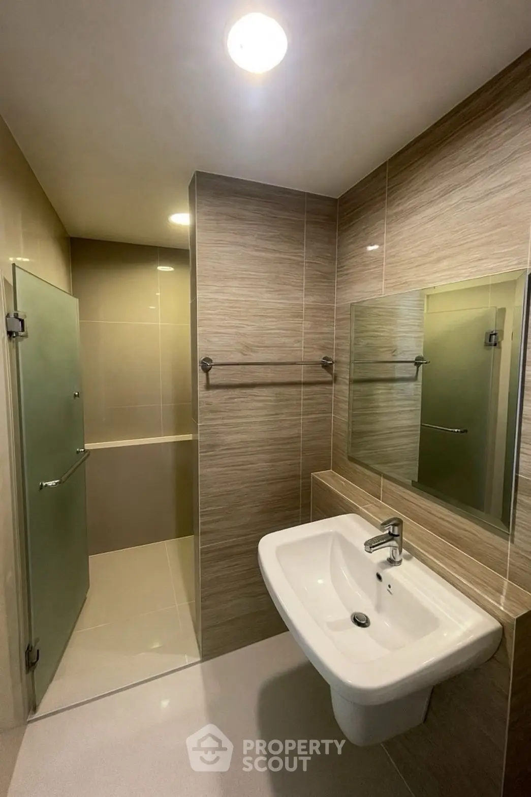 Modern bathroom with sleek sink and glass shower enclosure