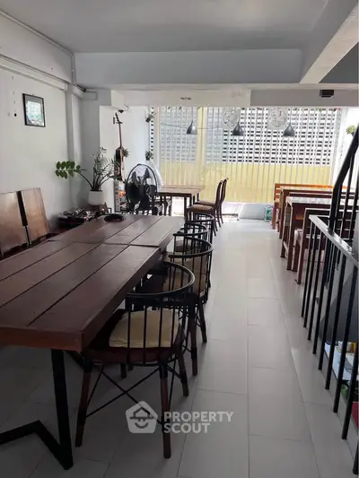 Spacious balcony with modern seating and city view, perfect for relaxation and gatherings.