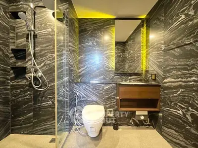 Luxurious modern bathroom with elegant marble walls and sleek fixtures